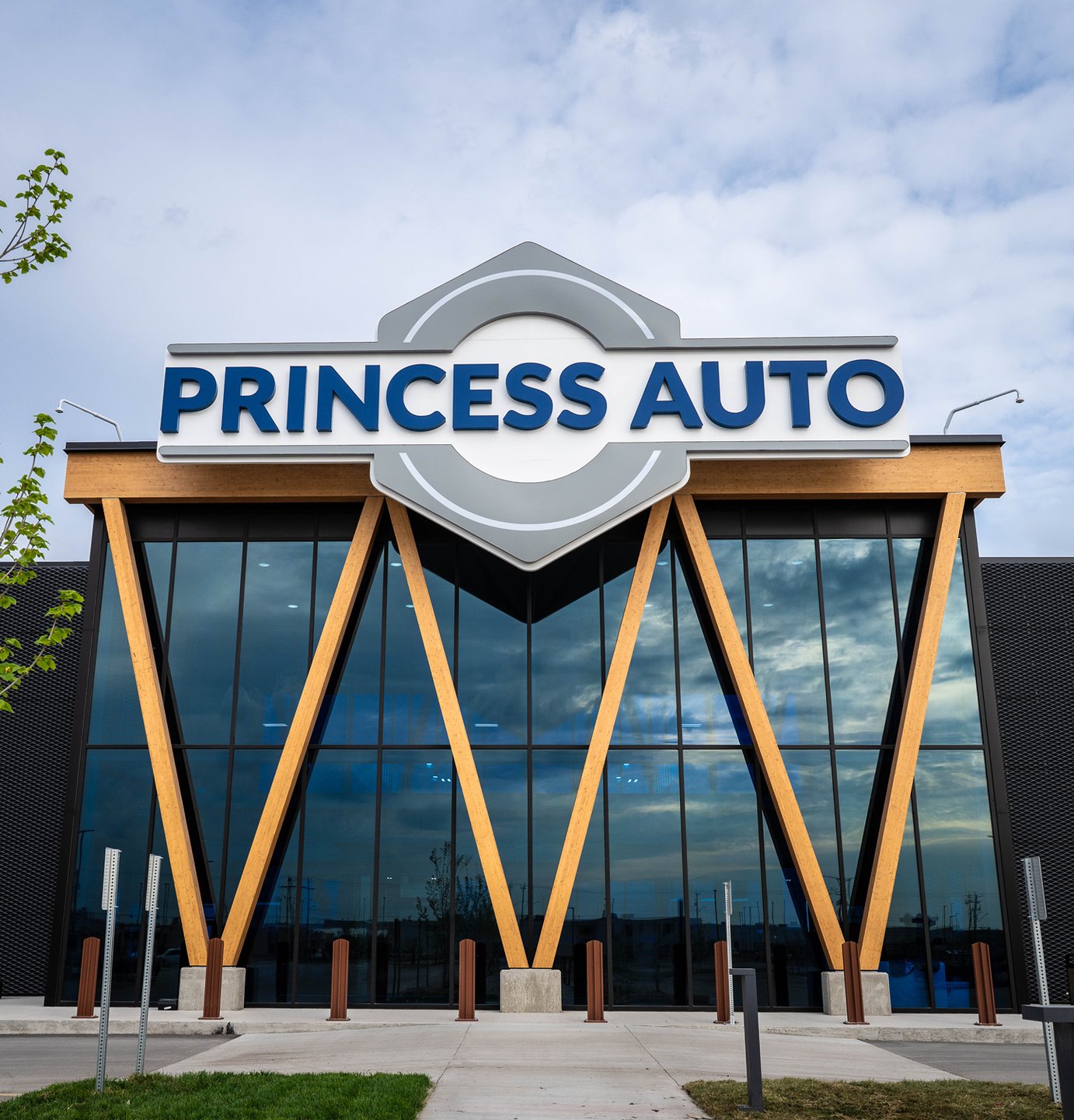 The Princess Auto flagship storefront: the hexagonal sign over a glass facade framed by angled wood beams