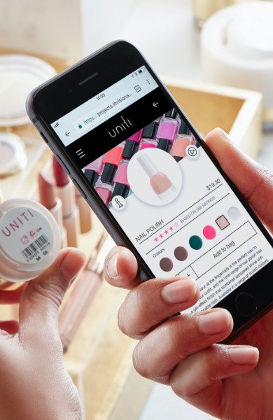 A shopper scans a nail polish pot with a smartphone and sees its product page
