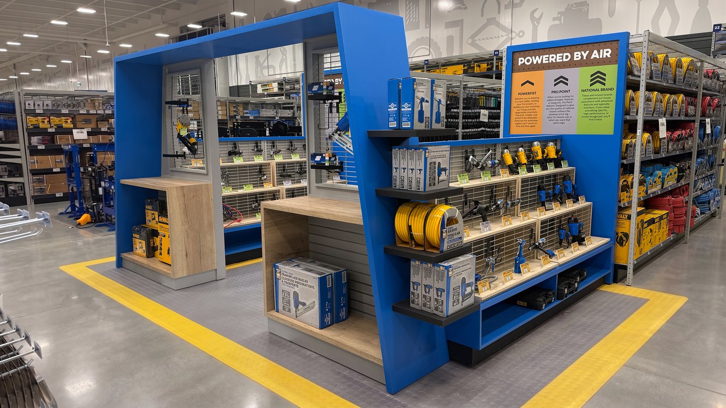 The finished Air & Power area: a blue display frame of air tools and compressors with 'Powered by Air' signage
