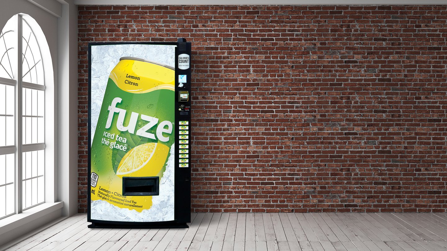 A vending machine wrapped in Fuze Lemon iced tea branding against a brick wall