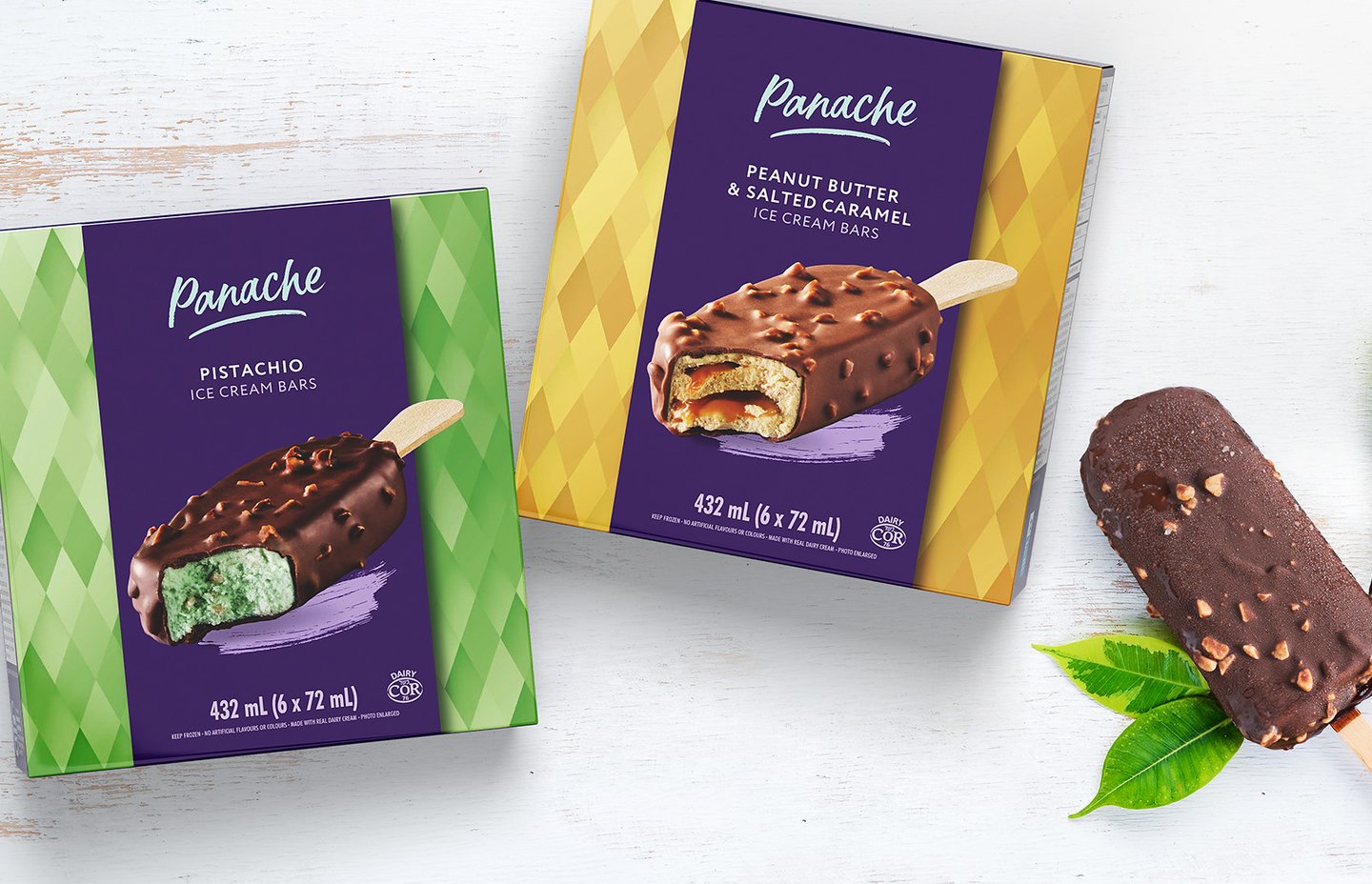 Panache Pistachio and Peanut Butter & Salted Caramel ice cream bar boxes, with a chocolate-coated bar beside them