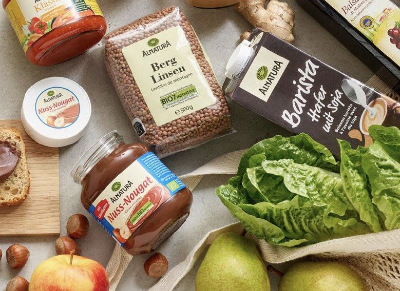 Alnatura organic products in Germany: lentils, nut-nougat spread and oat drink, with lettuce, apples and pears