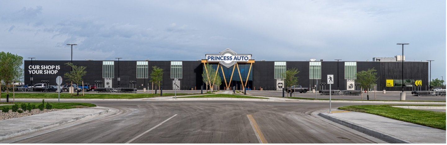 A wide view of the Princess Auto flagship store and its parking lot under a grey sky