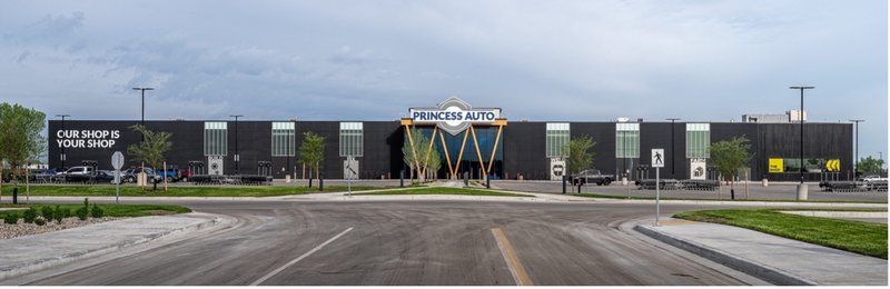 A wide view of the Princess Auto flagship store and its parking lot under a grey sky