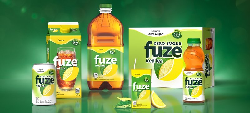 The Fuze iced tea family on green: Zero Sugar can, Lemon carton and bottle, Zero Sugar 12-pack and a 500 ml bottle