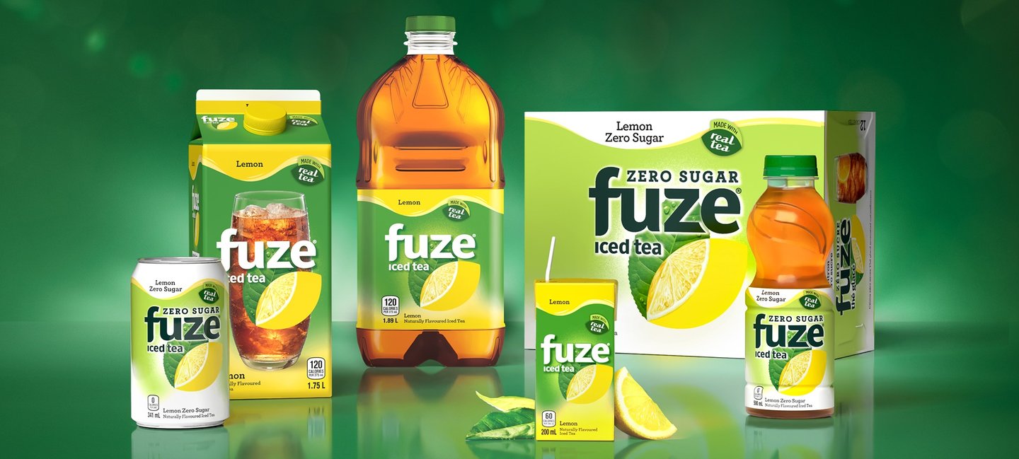 The Fuze iced tea family on green: Zero Sugar can, Lemon carton and bottle, Zero Sugar 12-pack and a 500 ml bottle