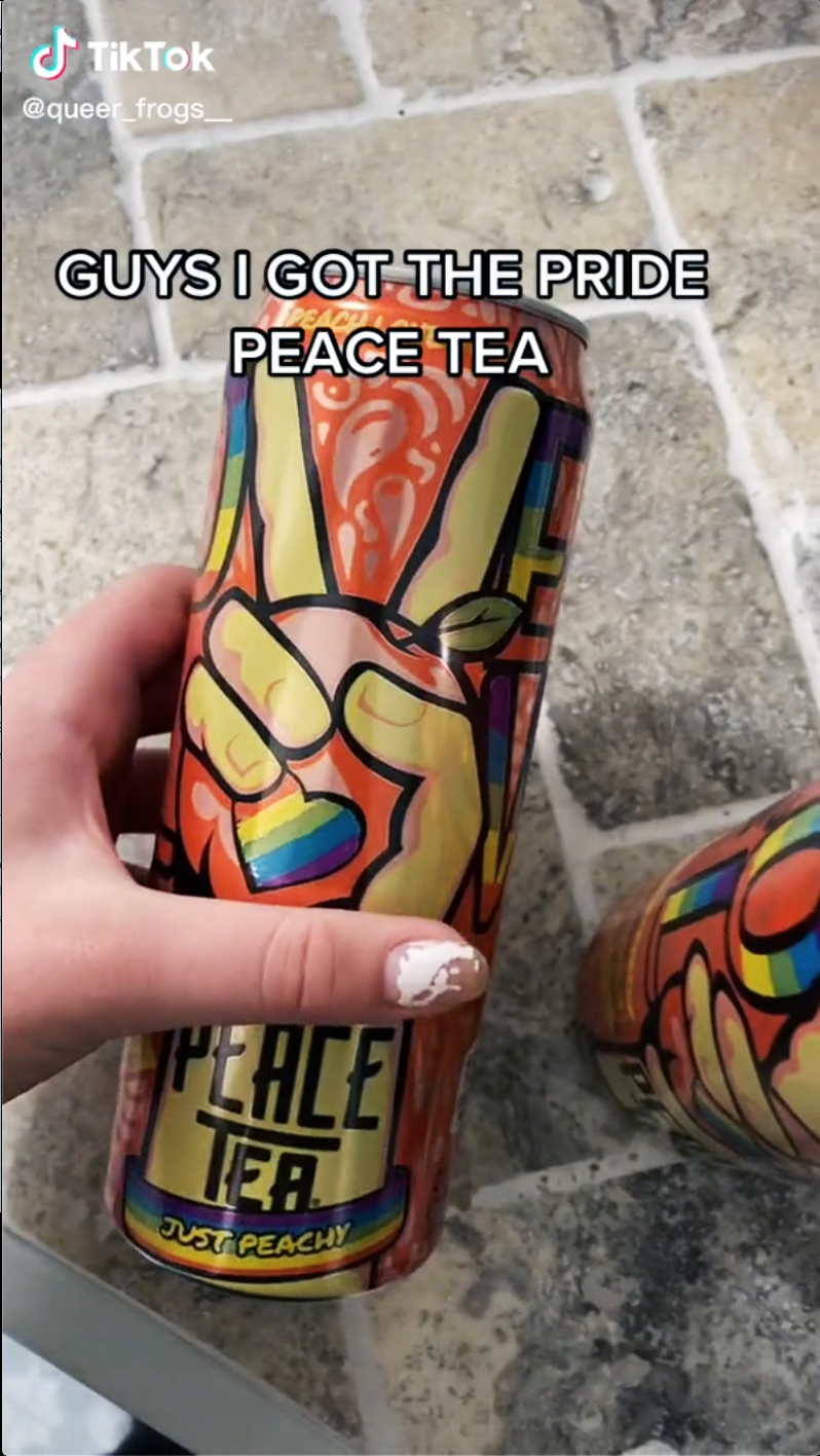 A TikTok screenshot of a hand holding a Peace Tea Pride can, captioned 'Guys I got the pride peace tea'