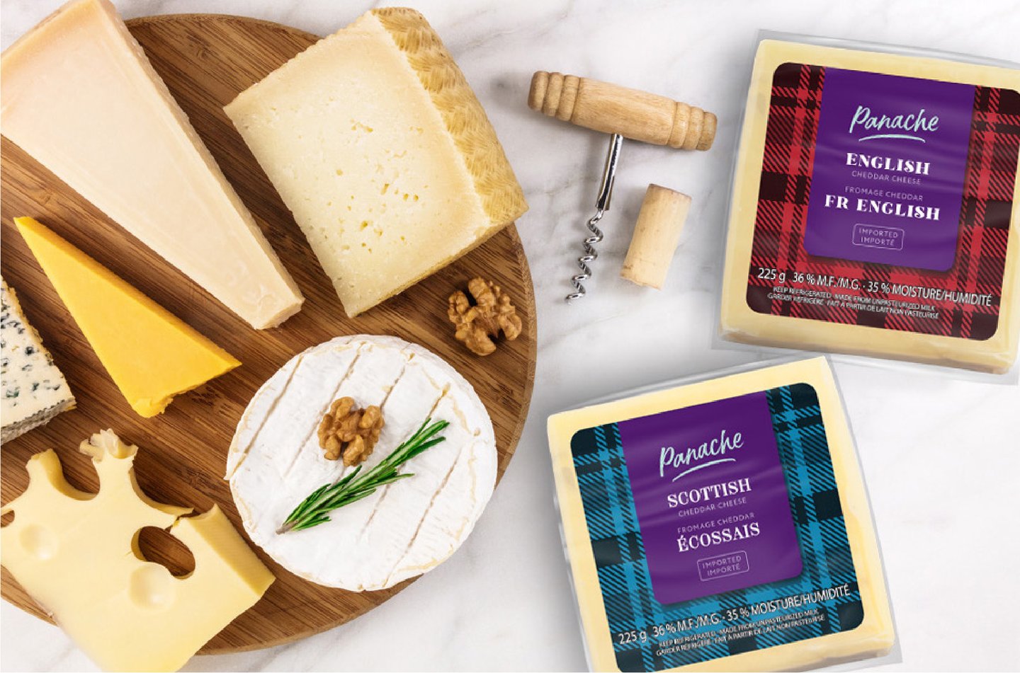 Panache English and Scottish cheddar blocks in tartan packs on a cheese board with brie, blue cheese and a corkscrew
