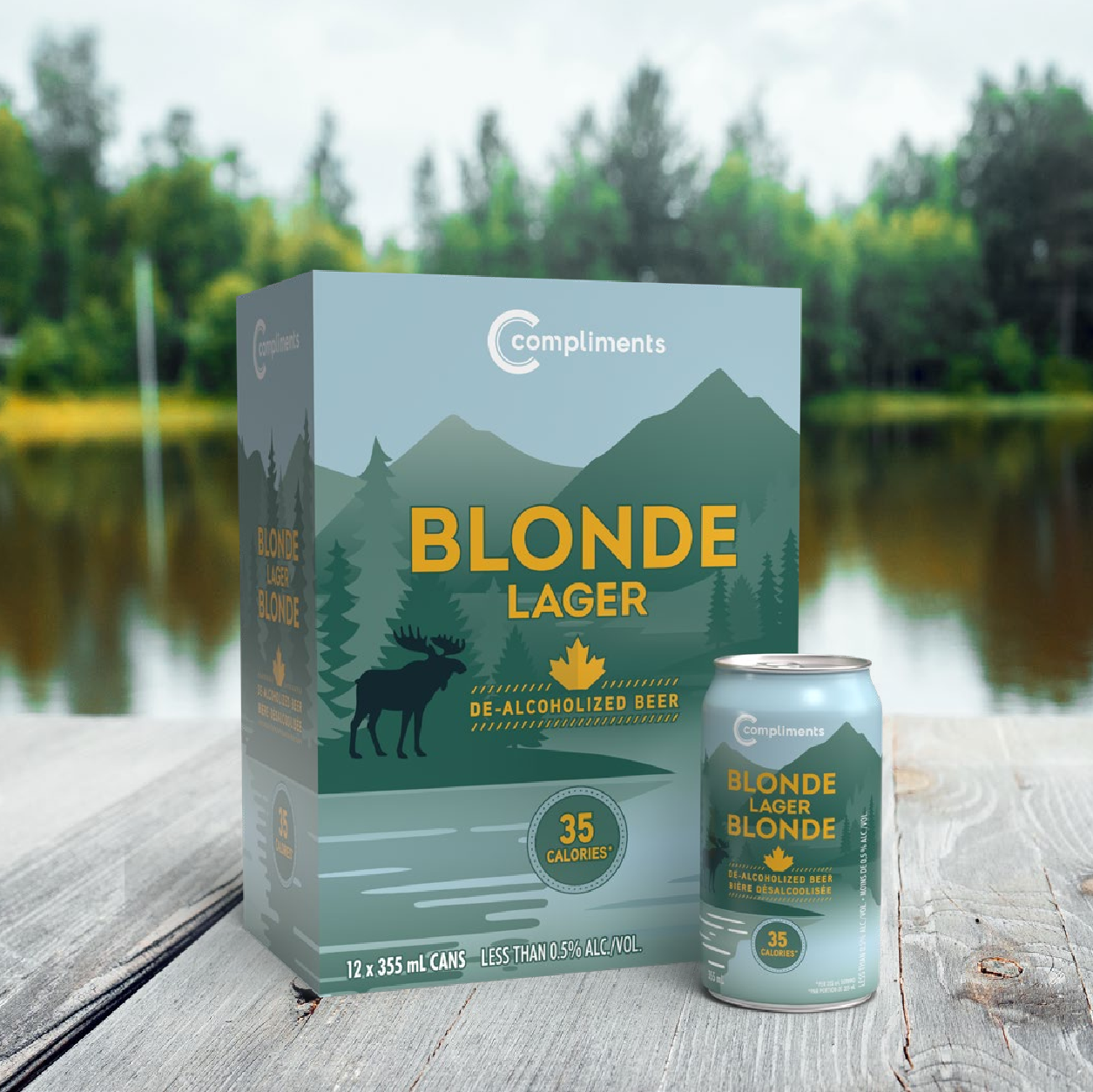 A Compliments Blonde Lager de-alcoholized beer 12-pack and can on a dock beside a lake