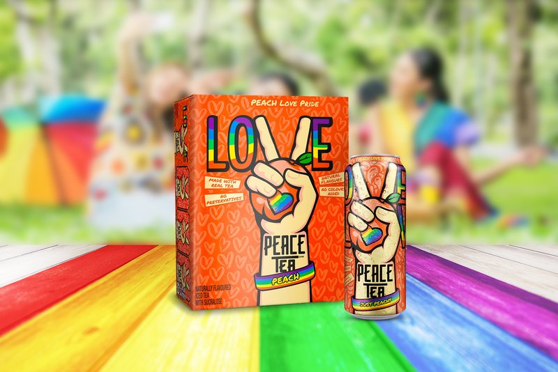 The Peace Tea Peach Love Pride 12-pack and can on rainbow boards at a park picnic