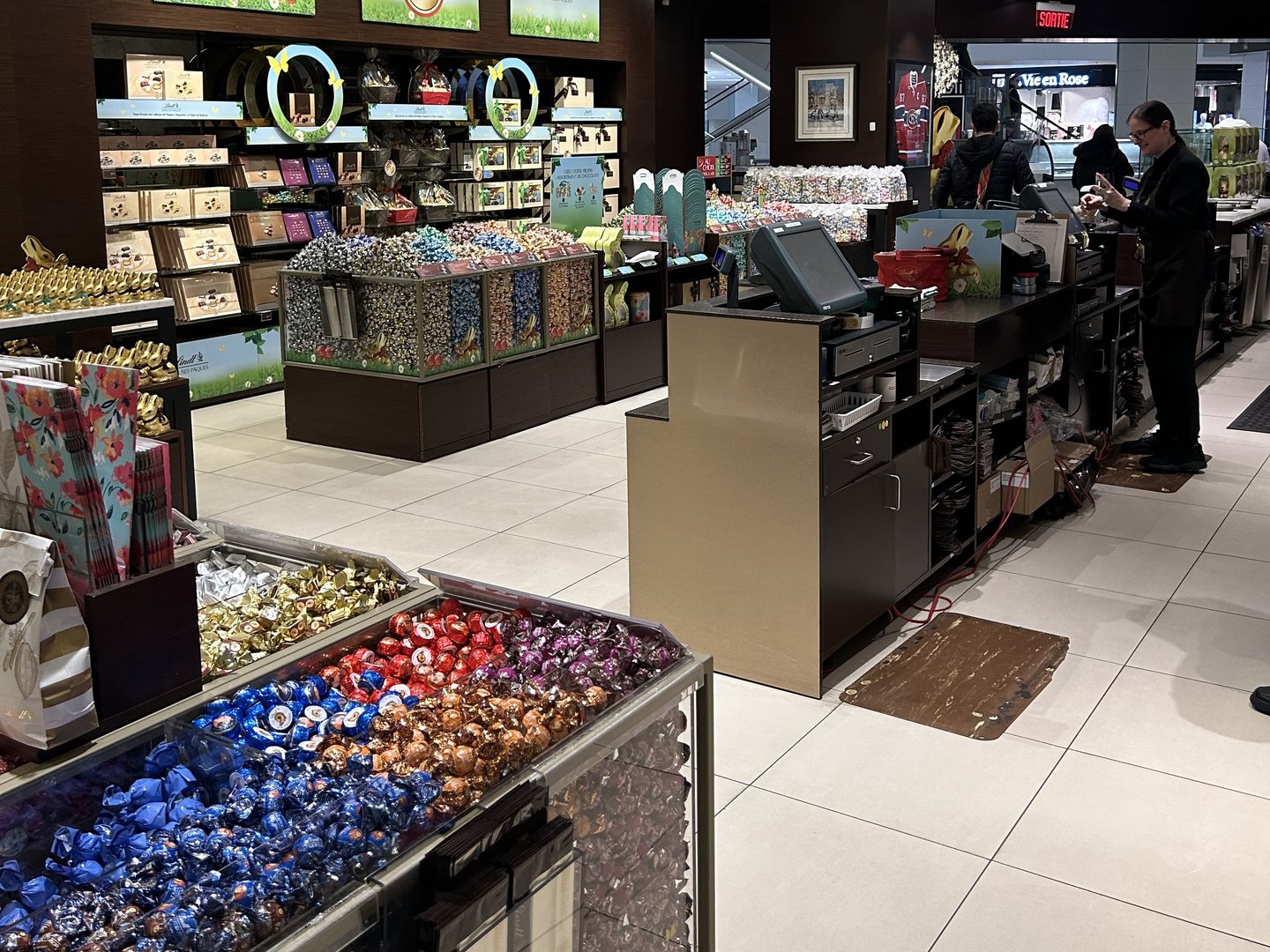 The old Lindt store: a cash desk hemmed in by displays, with staff and customers squeezed between