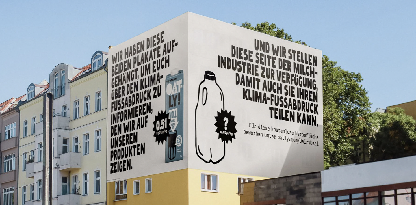 An Oatly mural on a Berlin building, in German, inviting the dairy industry to share its climate footprint beside Oatly's own