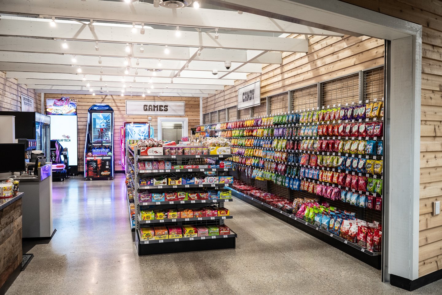 The games and candy area at Princess Auto: arcade machines beside a wall of candy bins