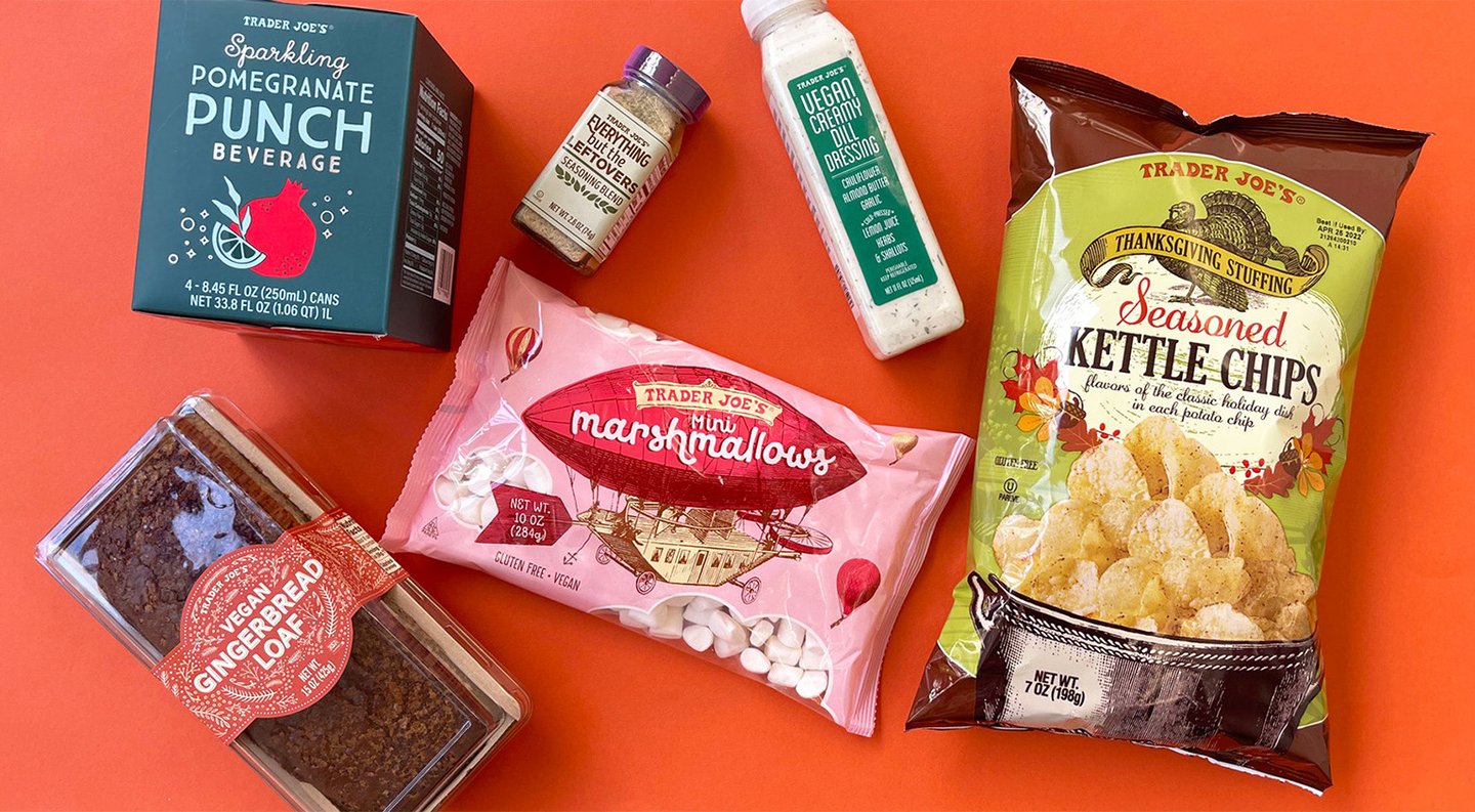 Trader Joe's Thanksgiving products on orange: sparkling pomegranate punch, seasoned kettle chips, mini marshmallows and gingerbread loaf