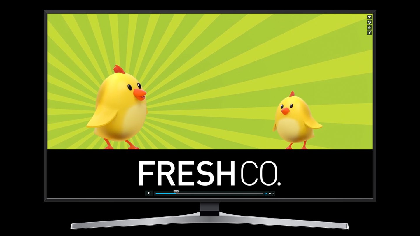 A still from the FreshCo TV spot on a television: two yellow chicks on a green sunburst above the FreshCo logo