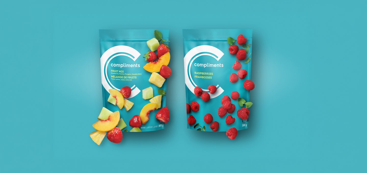 Compliments Fruit Mix and Raspberries frozen fruit bags on a teal background