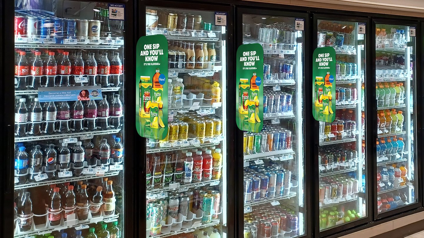 Fuze 'One sip and you'll know' blade signs on the doors of grocery store beverage coolers