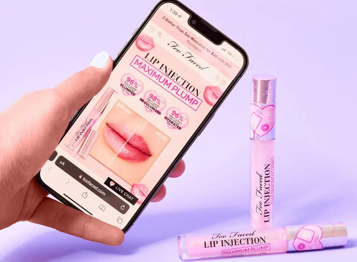 Too Faced Lip Injection products with NFC tags, tapped with a phone to open the brand page