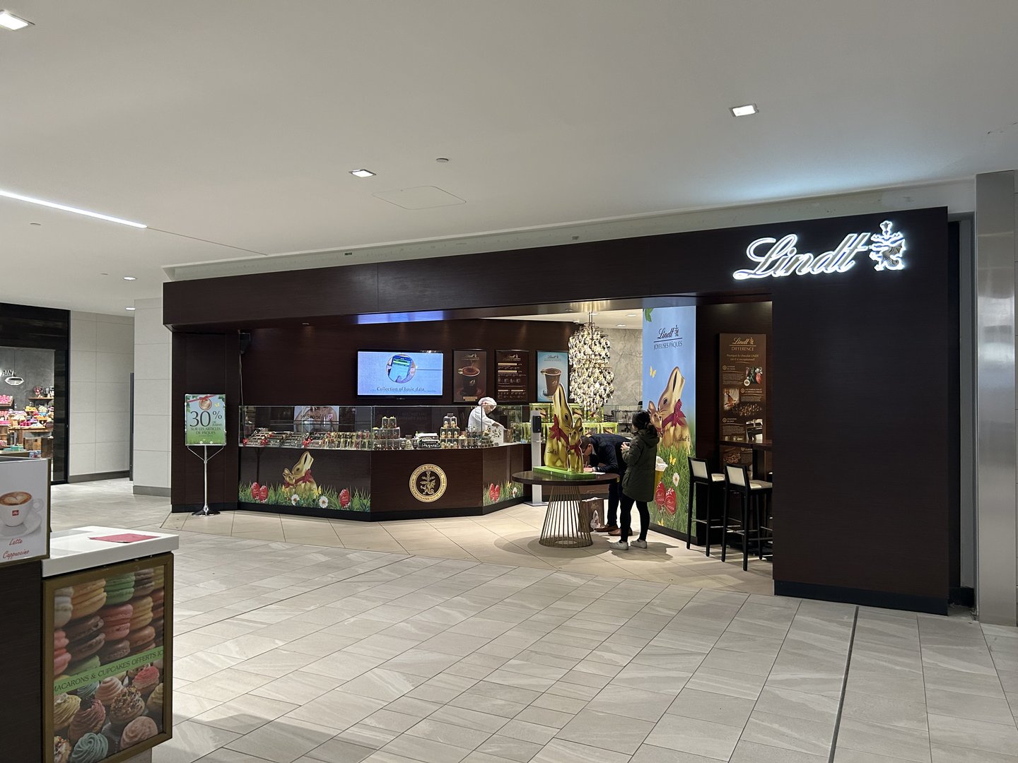 The old Lindt store entrance: a dark recessed shopfront with little view into the store