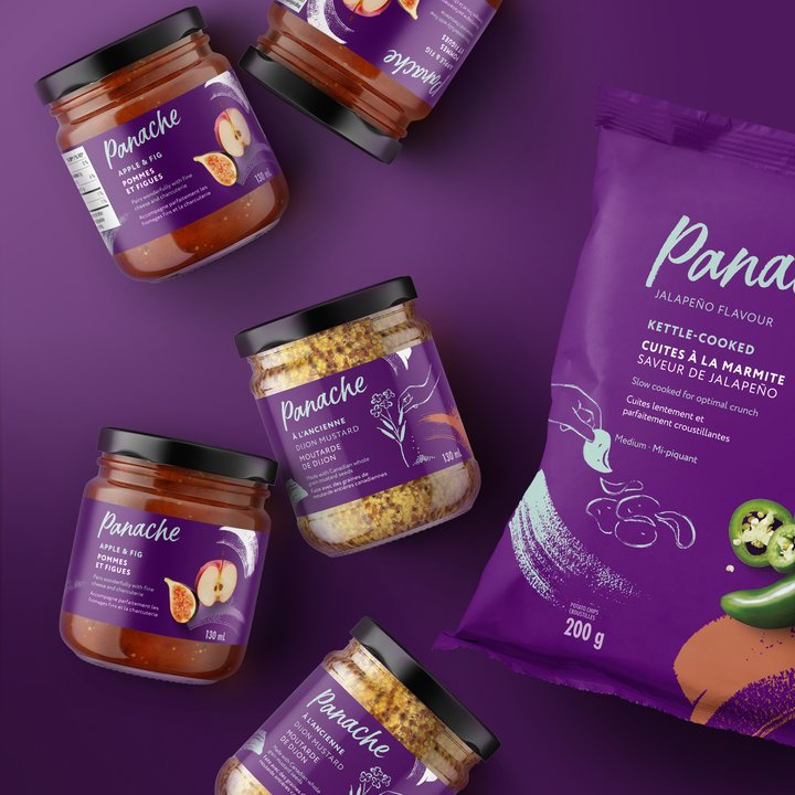 Panache jars of chutney, mustard and jam beside a bag of Panache jalapeno kettle cooked chips on purple