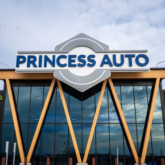 The Princess Auto flagship storefront: the hexagonal Princess Auto sign above a glass facade framed by angled wood beams