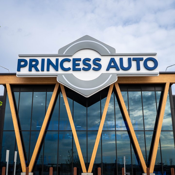 The Princess Auto flagship storefront: the hexagonal Princess Auto sign above a glass facade framed by angled wood beams
