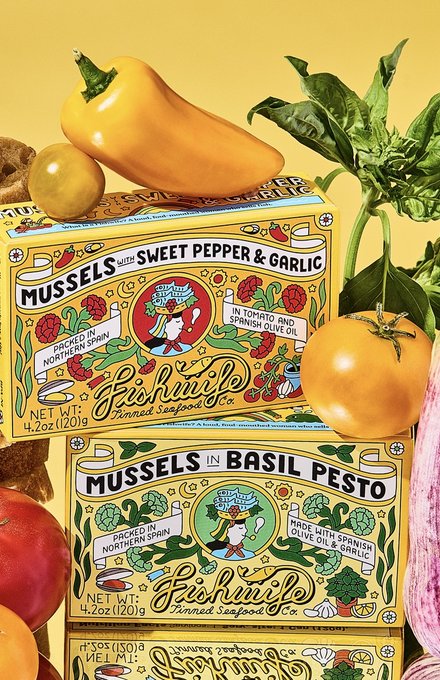 Fishwife tinned mussels in sweet pepper & garlic and basil pesto, among bread, tomatoes, basil, garlic and a pepper on yellow